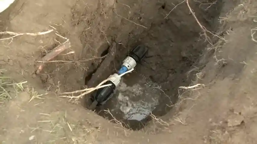 Wet soggy lawn area in Loveland Colorado neighborhood indicating underground pipe leak